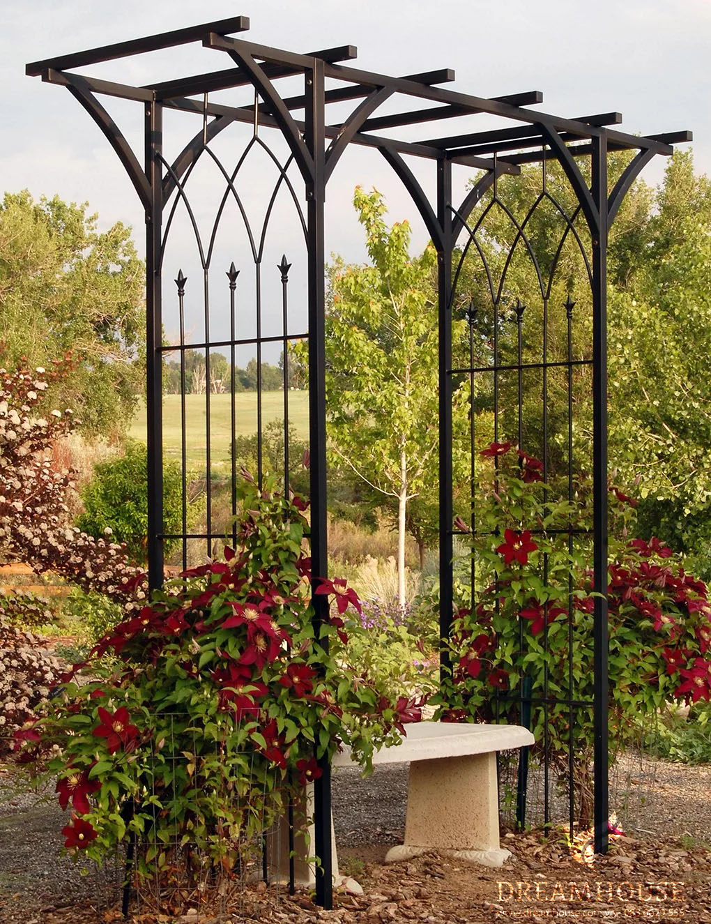 35-y-tuong-thiet-ke-canh-quan-san-vuon-cho-nam-2025-cho-nguoi-dam-me-24 Giàn cây kim loại đen quyến rũ được trang trí bằng những dây leo như cây kim ngân và hoa nhài.